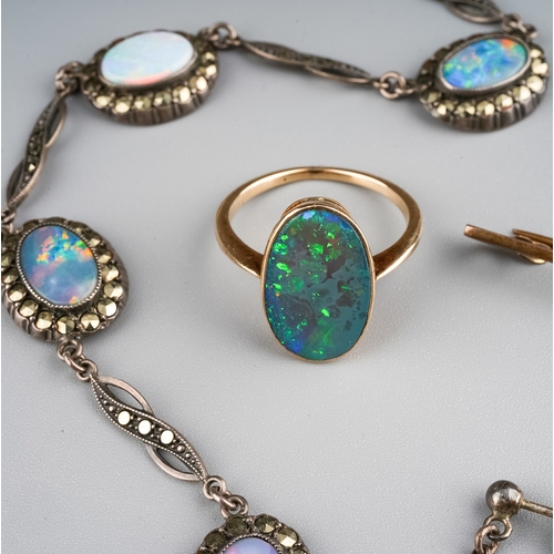 5 - A yellow gold and opal ring, set with a flat top oval opal, unmarked assessed as approx 9ct, size M1... 