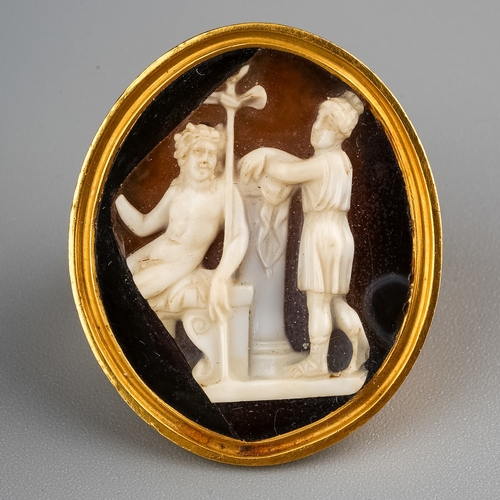 8 - A 19th century yellow gold and cameo ring, the 26mm x 21mm hardstone cameo carved depicting classica...