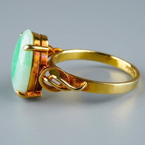 10 - A 14k yellow gold and jade ring, set with an oval cabochon stone in four claw settings, detailed sho... 