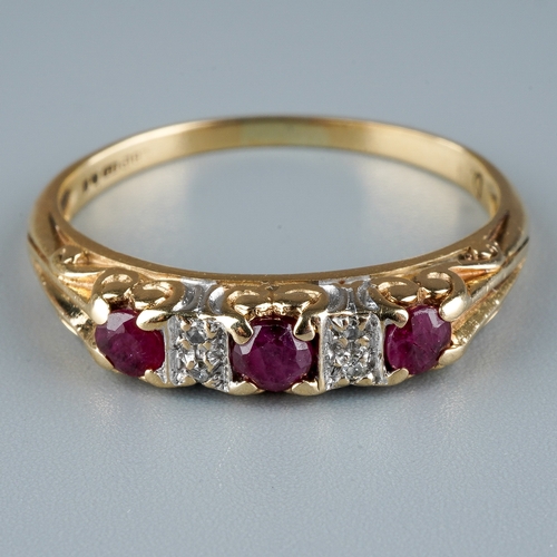 11 - A 9ct yellow gold ruby and diamond ring, set with three round-cut rubies with diamond-chip spacers, ... 