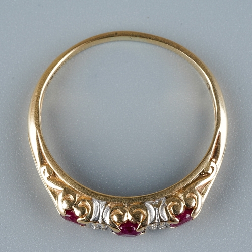 11 - A 9ct yellow gold ruby and diamond ring, set with three round-cut rubies with diamond-chip spacers, ... 