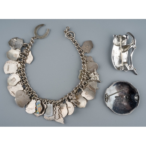 34 - A silver charm bracelet, with enamelled souvenir charms; a Scottish silver brooch, makers mark RA, G... 