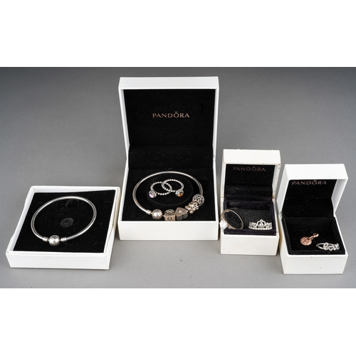 61 - A collection of silver jewellery, including two Pandora bracelets, rings, silver and CZ rings, gold-... 