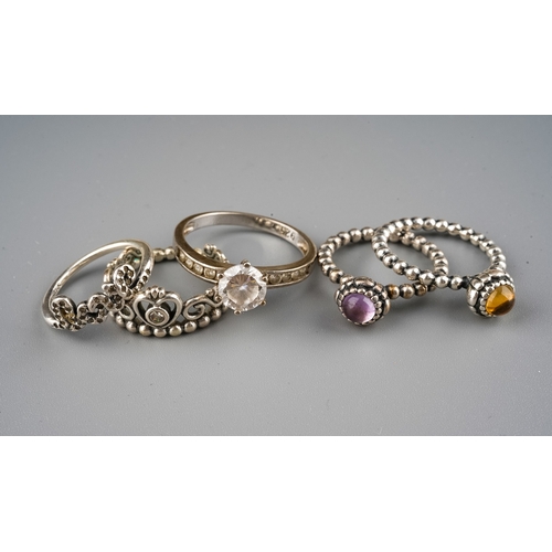 61 - A collection of silver jewellery, including two Pandora bracelets, rings, silver and CZ rings, gold-... 