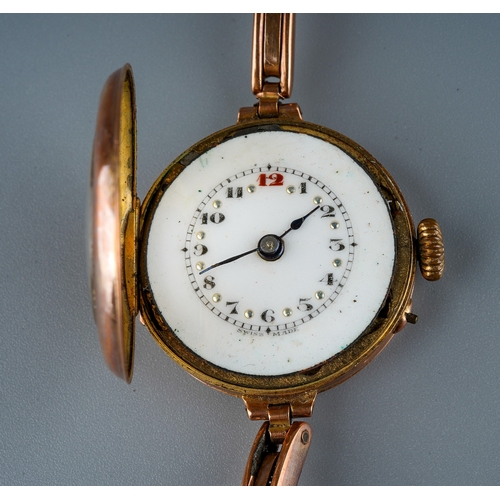 75 - A 1930s 9ct rose gold watch, white enamel dial with Arabic numerals, integral expanding 9ct stap, to... 