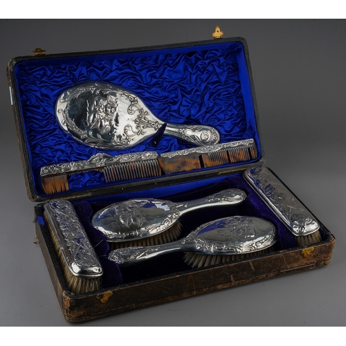 208 - A matched Edwardian silver mounted dressing table service to include: a pair of hair brushes, a pair... 