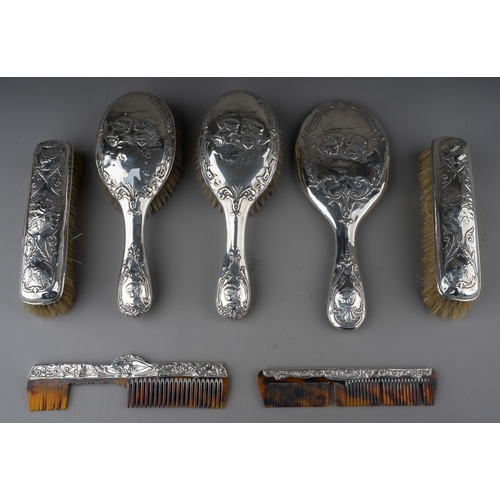 208 - A matched Edwardian silver mounted dressing table service to include: a pair of hair brushes, a pair... 