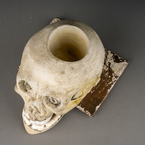 103 - A 19th Century parian inkwell modelled as a skull with recess to top of skull, glazed teeth and arti... 