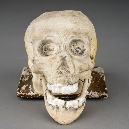 103 - A 19th Century parian inkwell modelled as a skull with recess to top of skull, glazed teeth and arti... 