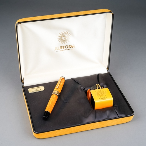 363 - An Italian Aurora amber marbled fountain pen with 18Kt gold nib, stamped 18K 750, the cover with Gre... 