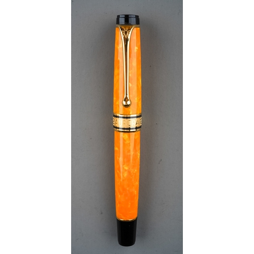 363 - An Italian Aurora amber marbled fountain pen with 18Kt gold nib, stamped 18K 750, the cover with Gre... 