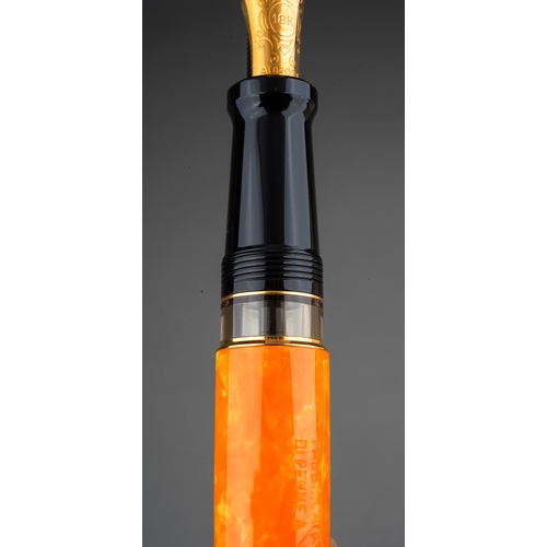 363 - An Italian Aurora amber marbled fountain pen with 18Kt gold nib, stamped 18K 750, the cover with Gre... 