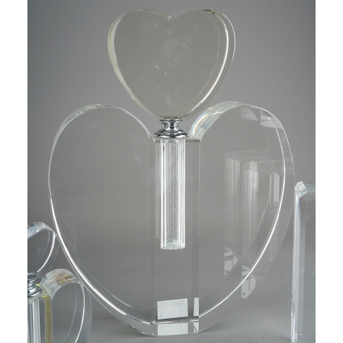 529 - A collection of three various glass scent bottles to include large heart shaped, small heart shaped ... 