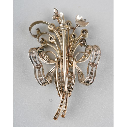 49 - A white gold and diamond spray brooch, the bouquet of flowers tied with a pearl-set ribbon, set thro... 