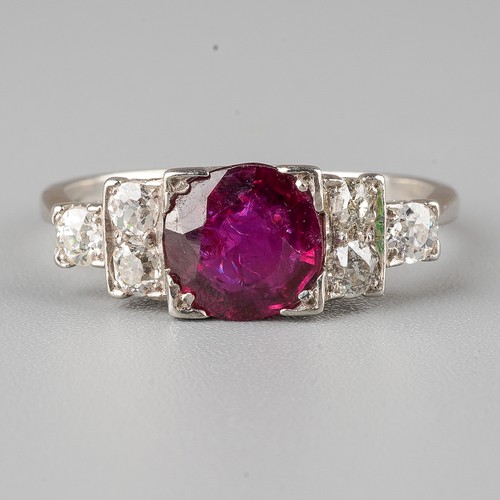 54 - An Art Deco style ruby and diamond ring, set with a round-cut ruby flanked by six old-cut diamonds, ... 