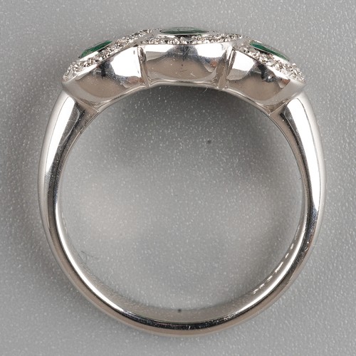 57 - An 18ct white gold emerald and diamond ring, set with three oval-cut emeralds within borders of roun... 