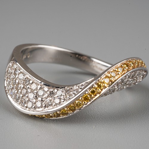 59 - An 18ct white gold yellow and white diamond dress ring, set with a wave of yellow round-brilliant cu... 