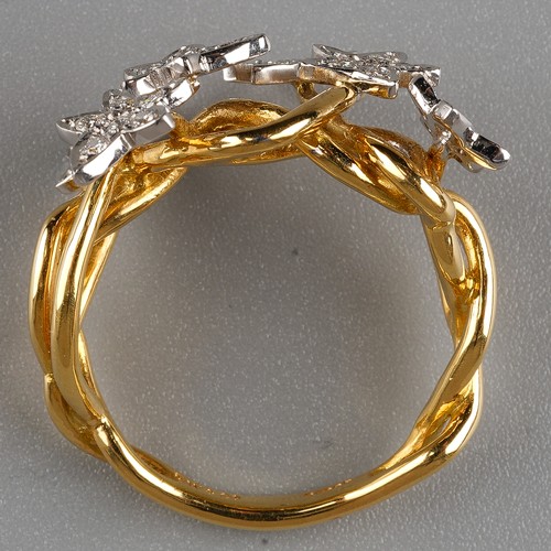 60 - An 18ct gold and diamond dress ring, the intertwined shank applied with six stars set with round bri... 