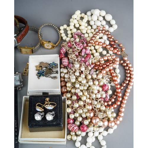 62 - A collection of costume jewellery, including a silver bangle, beads, necklaces, brooches, earrings, ... 