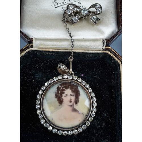 69 - A 19th century foliate pendant, set with paste stones and a pearl drop, silver settings on yellow me... 