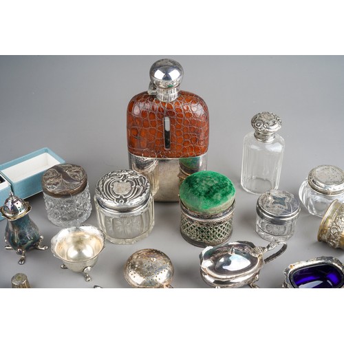 228 - A collection of silver, including eleven silver napkin rings, silver topped dressing table jars, spo... 