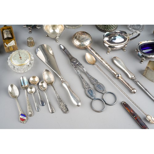 228 - A collection of silver, including eleven silver napkin rings, silver topped dressing table jars, spo... 