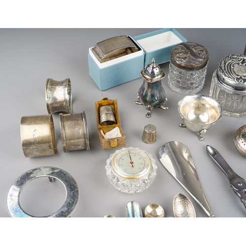 228 - A collection of silver, including eleven silver napkin rings, silver topped dressing table jars, spo... 