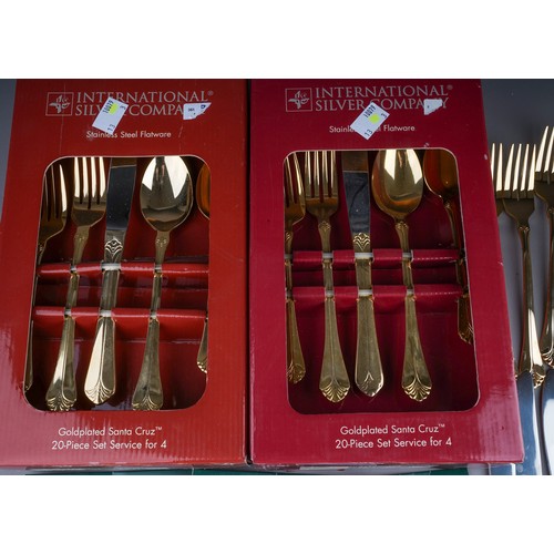 233 - Two boxed gold plated Santa Cruz 20 piece cutlery sets together with another 20 piece loose set and ... 