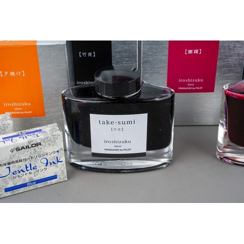 403 - A collection of ten Pilot Iroshizuku ink bottles, various colour pen inks, in oval glass bottles wit... 