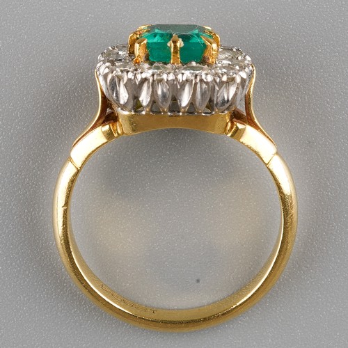 463 - An emerald and diamond square cluster ring, set with a square-cut emerald surrounded by twelve round... 