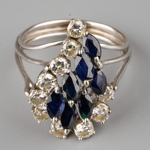 466 - A 14k white gold diamond and sapphire dress ring, set with round brilliant-cut diamonds and marquise... 