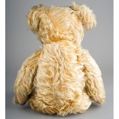 355 - A 1930's Merrythought teddy bear, with blonde mohair, one orange and black glass eyes, black stitche... 