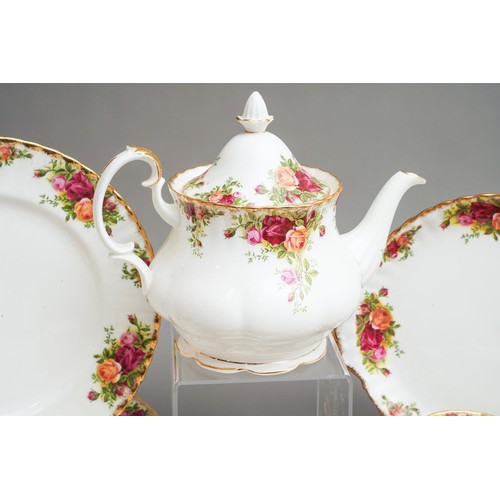 631 - Royal Albert Country Roses tea and dinner wares to include tea pot, dinner plates, trios, cake plate... 