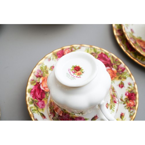 631 - Royal Albert Country Roses tea and dinner wares to include tea pot, dinner plates, trios, cake plate... 