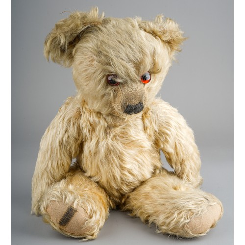 355 - A 1930's Merrythought teddy bear, with blonde mohair, one orange and black glass eyes, black stitche... 