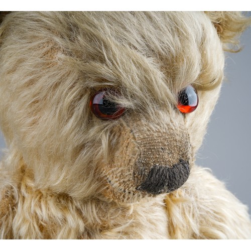 355 - A 1930's Merrythought teddy bear, with blonde mohair, one orange and black glass eyes, black stitche... 