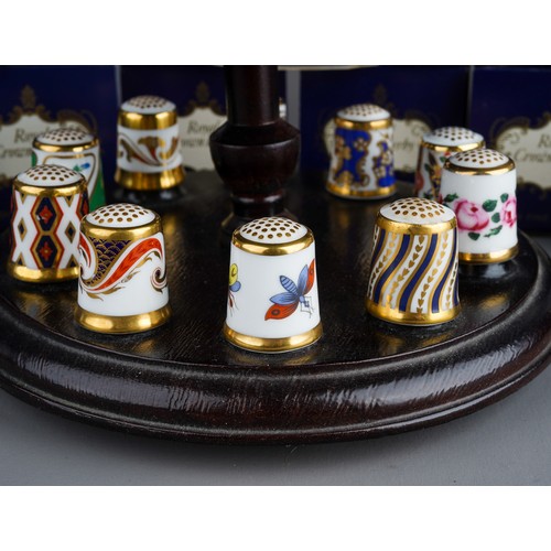 473 - A collection of  thirteen Royal Crown Derby thimbles, in numbered boxed and stand (1 bag)