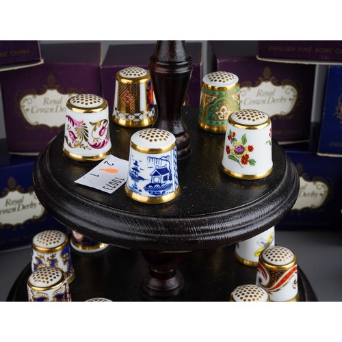 473 - A collection of  thirteen Royal Crown Derby thimbles, in numbered boxed and stand (1 bag)