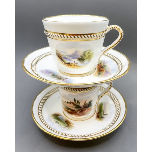 173 - Two English porcelain cups and saucers with hand painted panels and rope handles