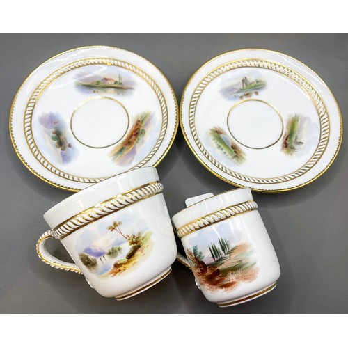 173 - Two English porcelain cups and saucers with hand painted panels and rope handles