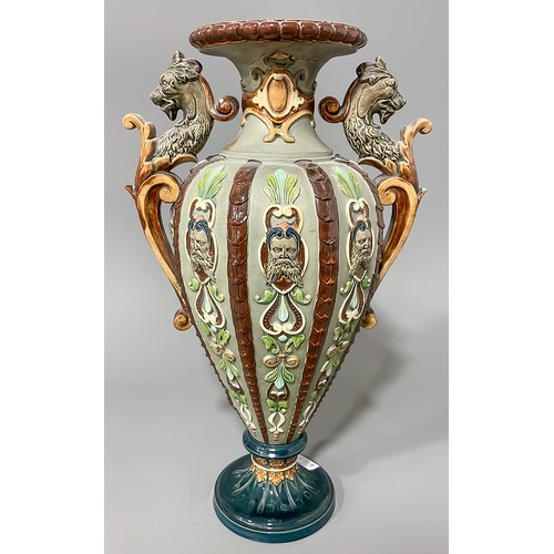 493 - A late 19th Century Majolica two handled vase, the sided with moulded strapwork with mask terminals,... 