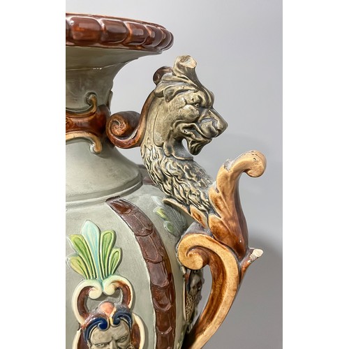 493 - A late 19th Century Majolica two handled vase, the sided with moulded strapwork with mask terminals,... 