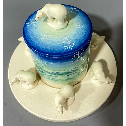 483 - A Dennis China Works preserve pot and stand,  cylindrical jar and cover with polar bear finial, the ... 