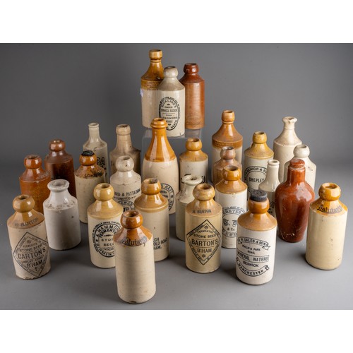 594 - Twenty-eight various stoneware beer and water bottles, some all cream, most with black transfer labe... 