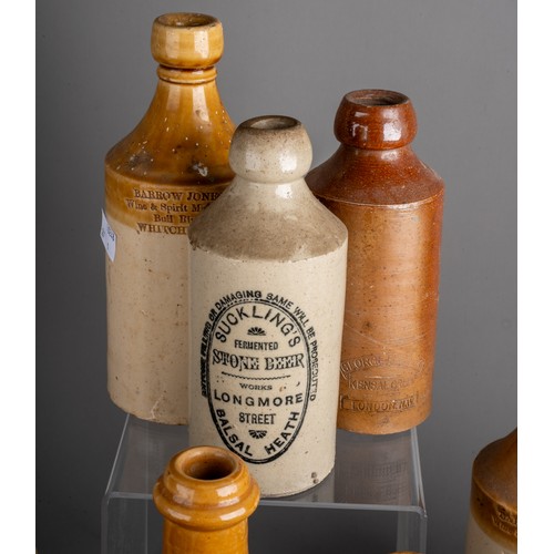 594 - Twenty-eight various stoneware beer and water bottles, some all cream, most with black transfer labe... 