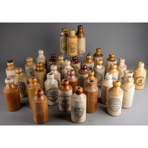 586 - Thirsty-Six stoneware ginger beer bottles, mostly Birmingham, Manchester, all with black transfer la... 