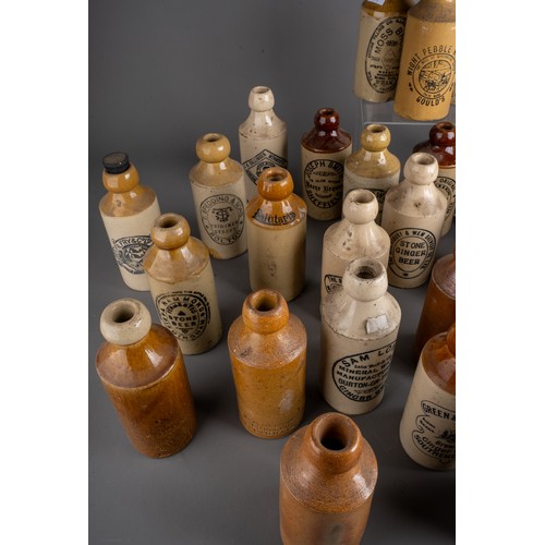 586 - Thirsty-Six stoneware ginger beer bottles, mostly Birmingham, Manchester, all with black transfer la... 