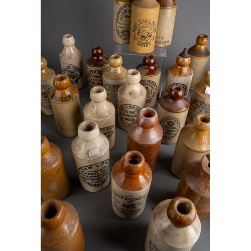 586 - Thirsty-Six stoneware ginger beer bottles, mostly Birmingham, Manchester, all with black transfer la... 