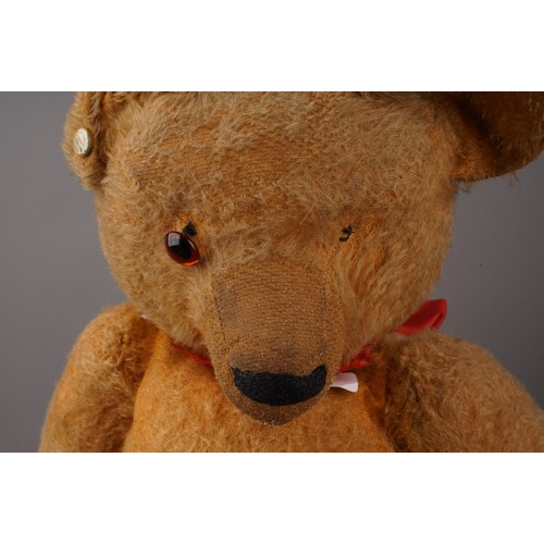 351 - A vintage large Chad Valley growler bear golden mohair, with one orange and black glass eye, pronoun... 