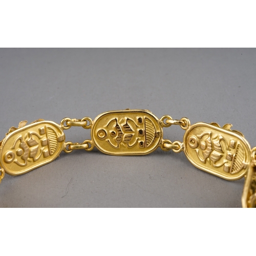 5 - An Egyptian yellow gold bracelet, with seven scarab beetle links set with turquoise glass, approx 18... 